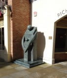 3m high, fine art bronze sculpture. Stylised adult standing, with arms round child, both facing. Green-grey patina on plinth.
