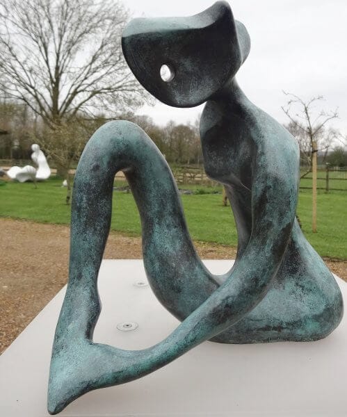 Contemplation Contemplation - an abstract sculpture of a figure in bronze. The figure's left arm appears to be holding its left foot. The finish is a mottled verdigris colour.