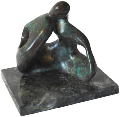 Abstract bronze sculpture of couple kissing.